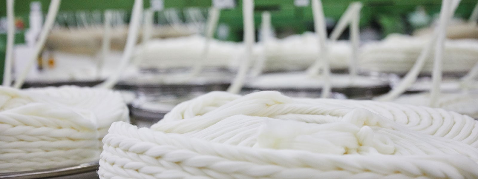 <h3 style="text-align: center;"><span style="color: #ffffff;"><strong>Discover the world’s best commercially available wool fabrics and yarns.</strong></span></h3>